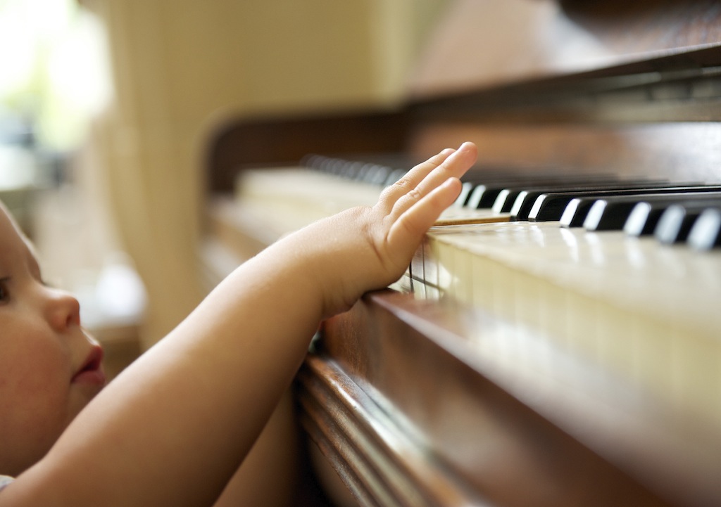closeup portrait of a baby playing the piano