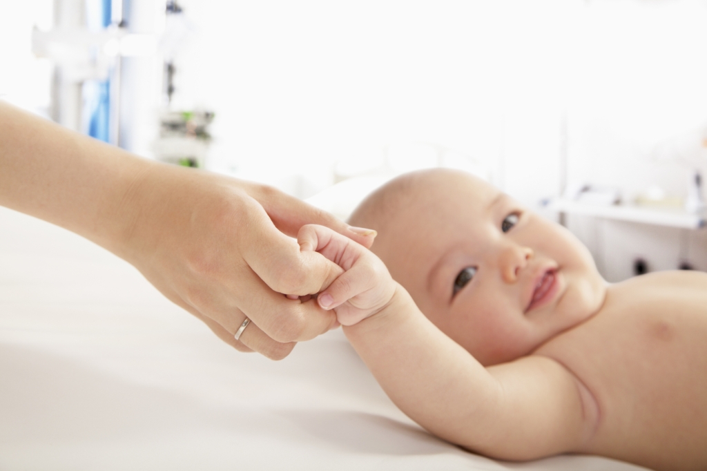adopting a child in Singapore - holding baby's hand