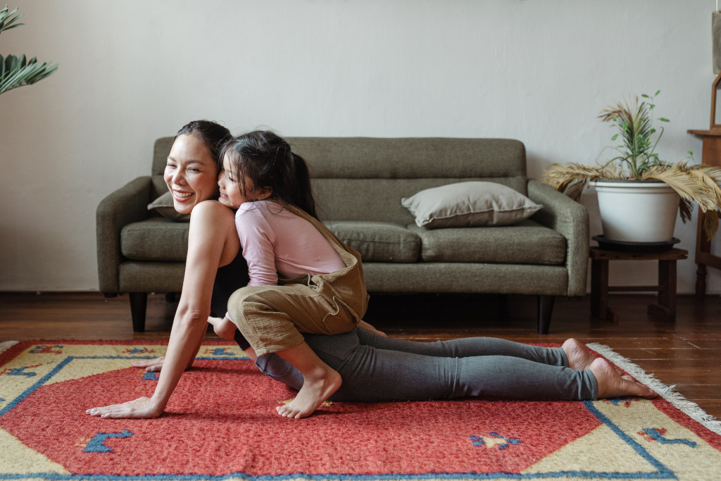 daughter with mum doing yoga