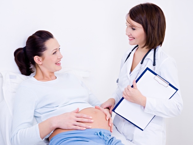 doctor talks with pregnant woman