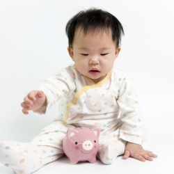 Asian baby with piggy bank