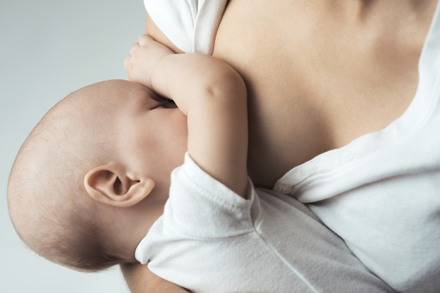 Baby feeds on MOM's breasts