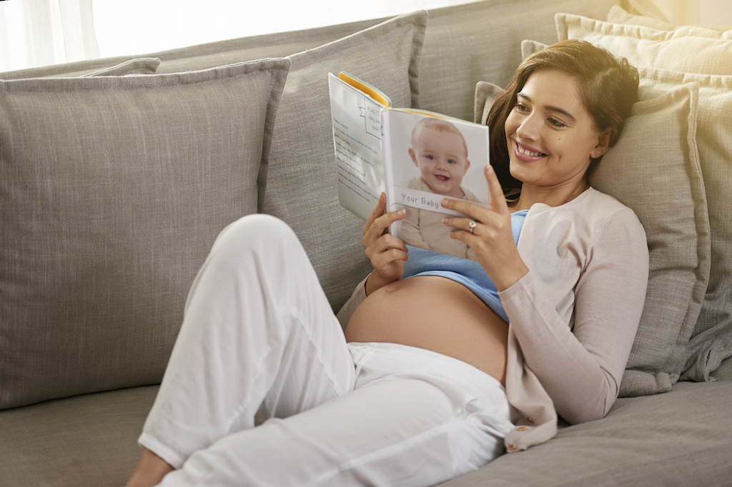 pregnant on sofa reading