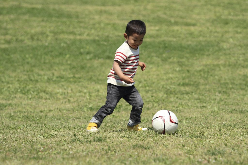 Japanese boy kicking a soccer ball (3 years old)