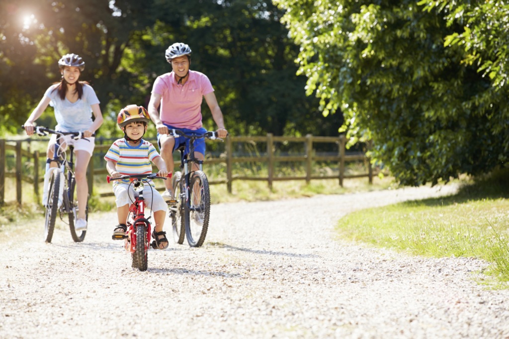 adopting a child in Singapore - happy family cycling