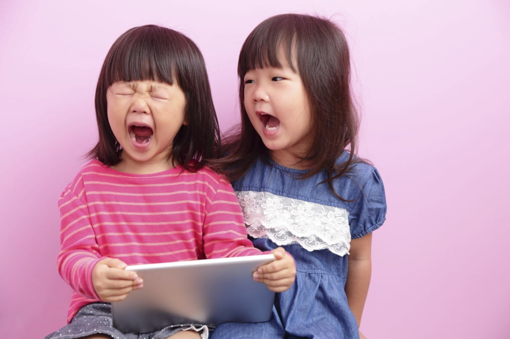 two little girls having argument crying ,Asian