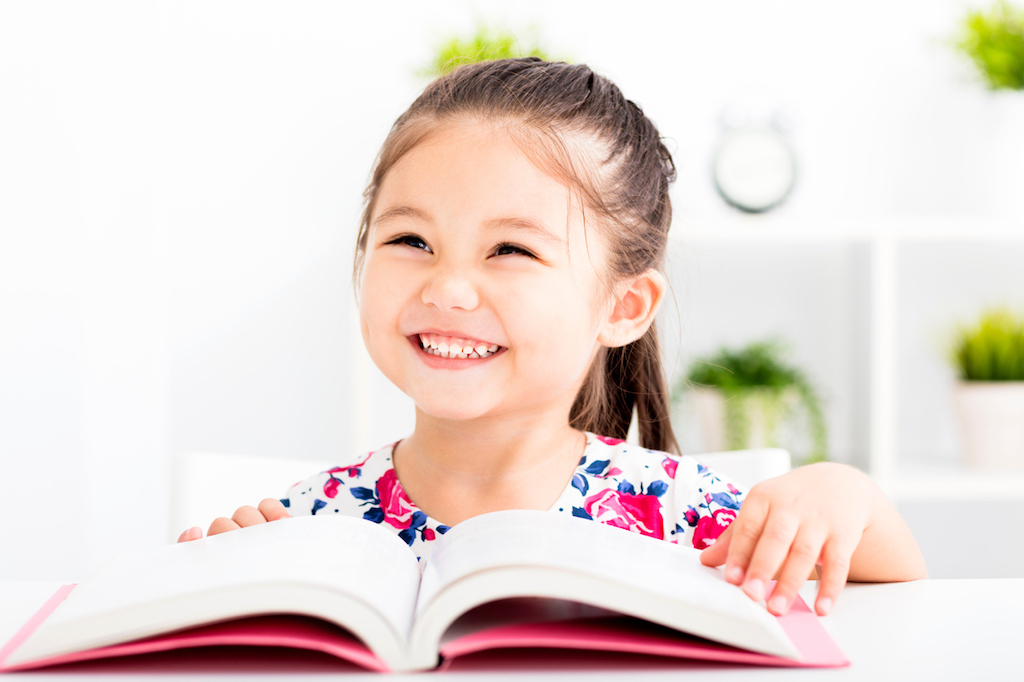 happy little girl Reading a Book