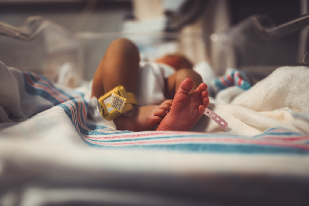 newborn baby in cot
