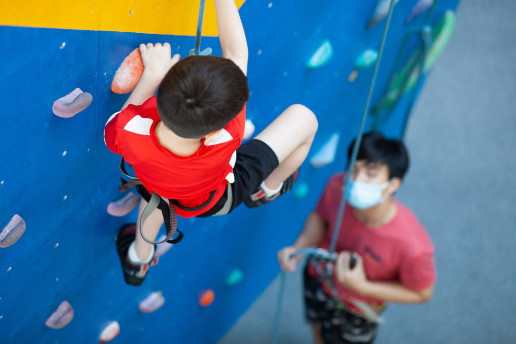 Kai and Elliott doing rock climbing for kids