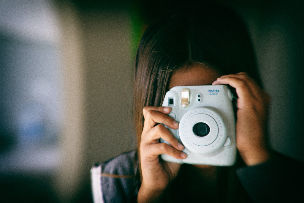 child holding camera