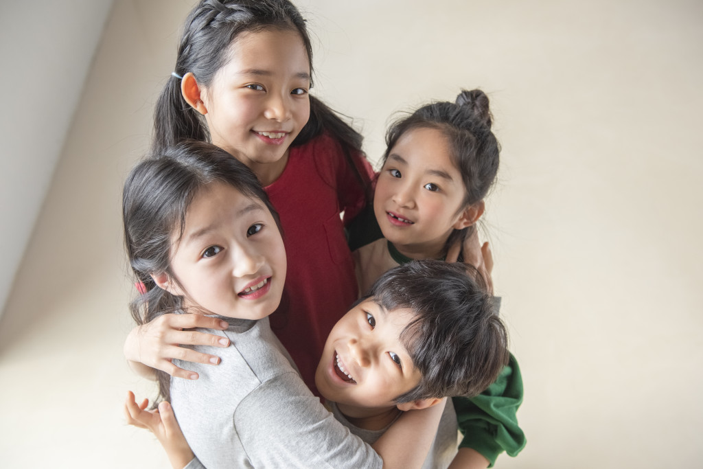 four hugging kids