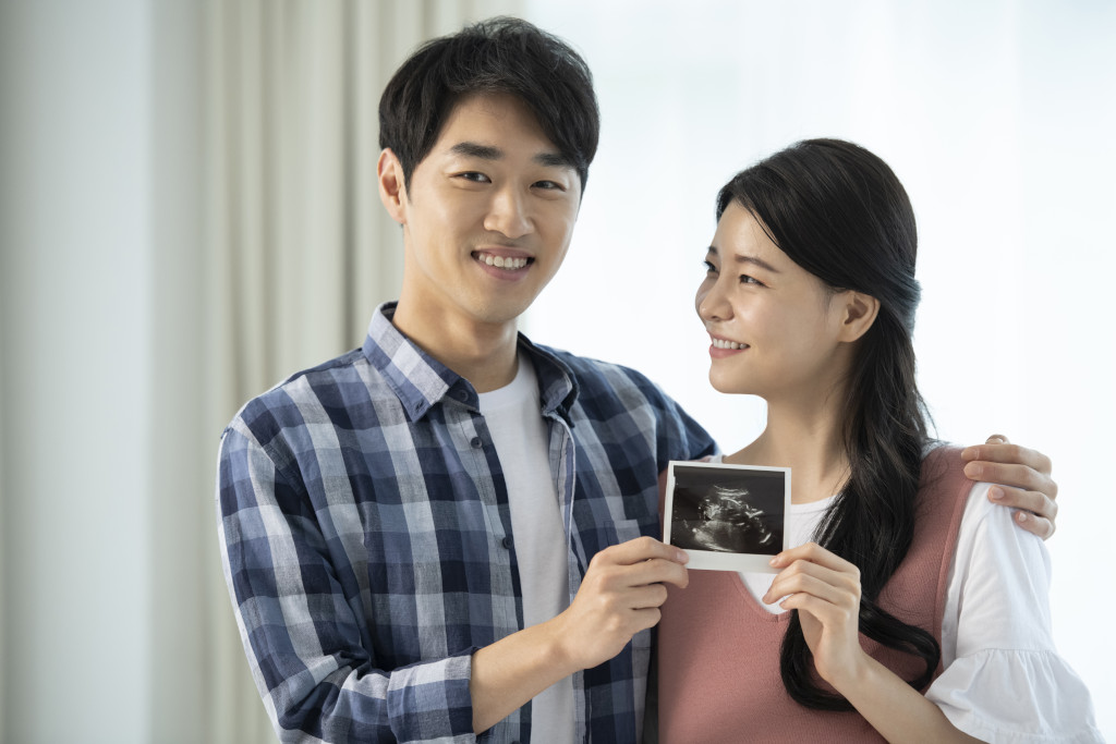 future dad & mum with ultrasound scan