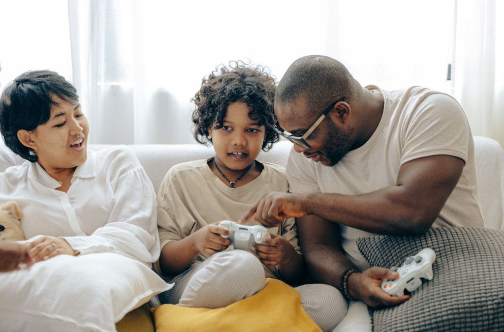 parents and kids entertained playing video games