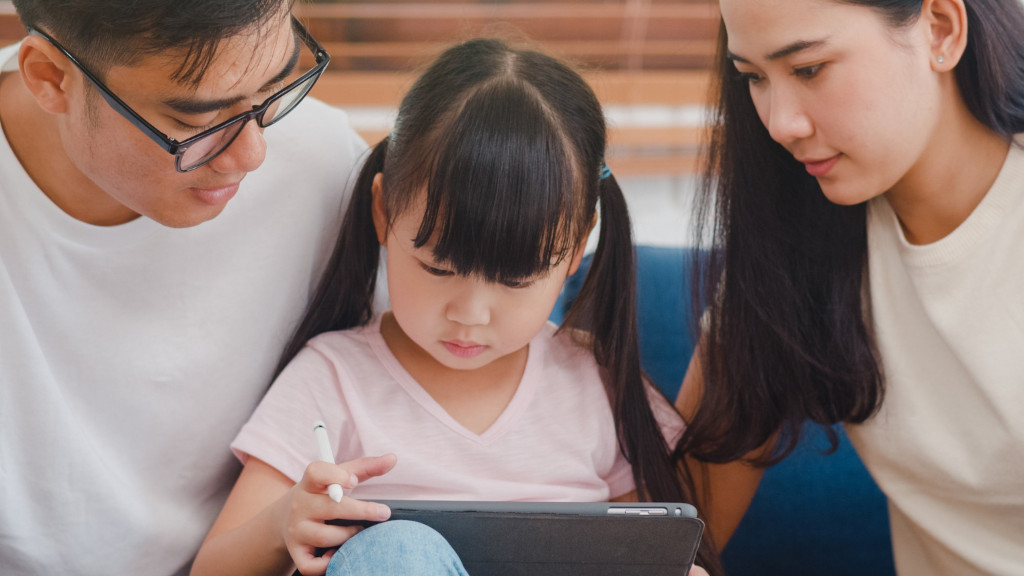 myopic parents and daughter looking at a screen