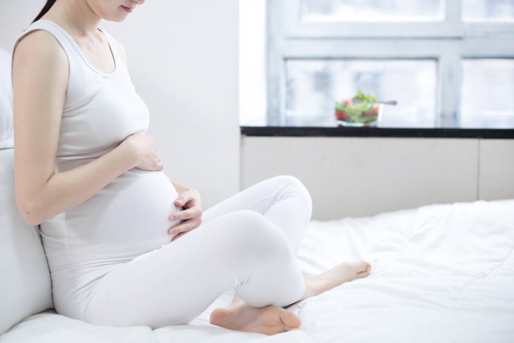 pregnant mum on bed