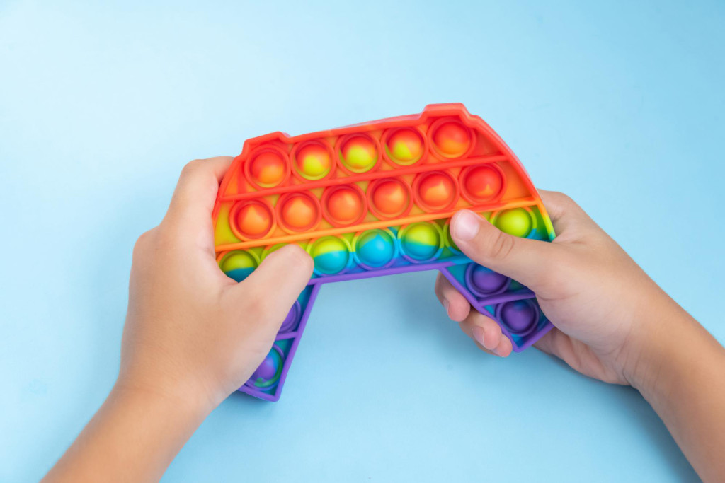 child playing with pop-it toy