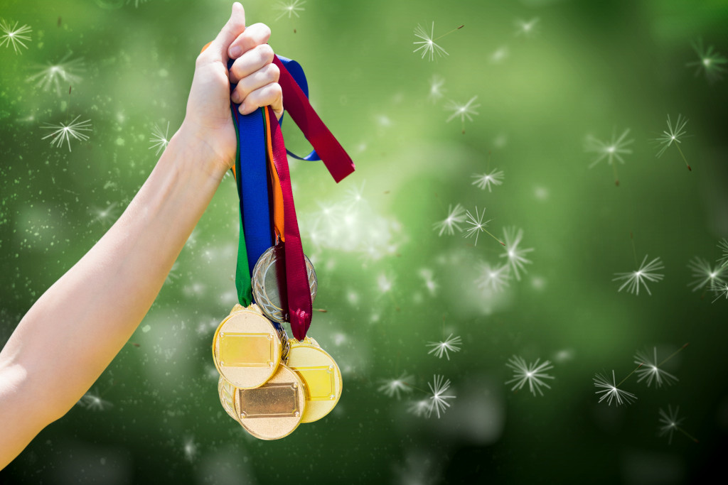 child holding medals to illustrate parent-child dynamics