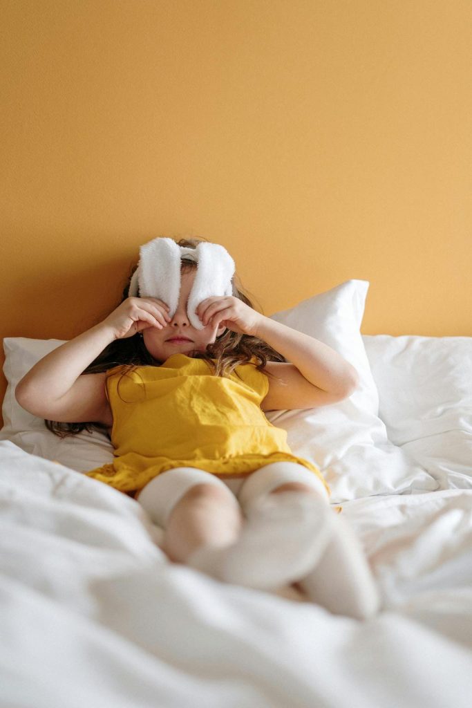girl-in-bed-covering-eyes-with-bunny-ears-pexels-cottonbro-studio-3992193-683x1024.jpg